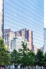 Fototapeta na wymiar New York / USA - 06-02-2016: Reflection of the New York Skyline in the Windows of Four World Trade Center in New York, USA