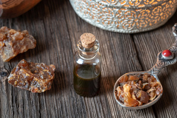 A bottle of myrrh essential oil with myrrh resin crystals