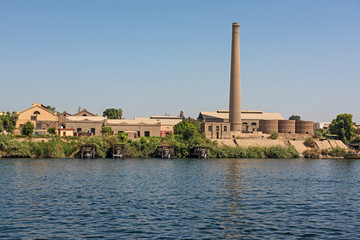 Obraz premium Landscape view of large sugar cane factory on river nile in Egypt