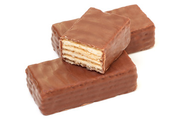 Sweet waffle candies coated with chocolate. One is sliced