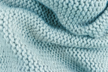 light blue cotton knitted fabric texture background with folds. toned image