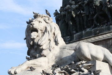 new and ancient, lion statue in the cathedral square of milan
