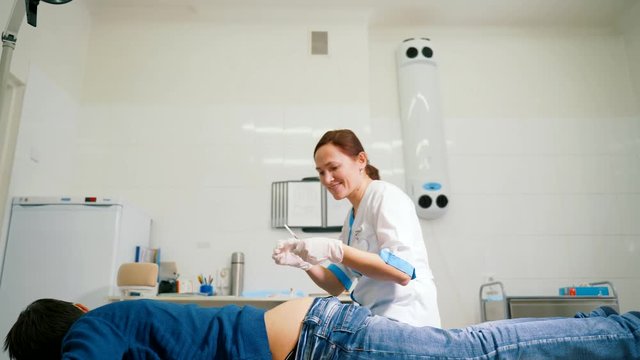 Woman doctor makes an intramuscular injection to the gluteus maximus muscle.