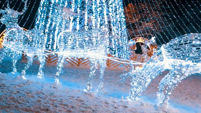 Christmas tree at the snowy night with street lights in European city