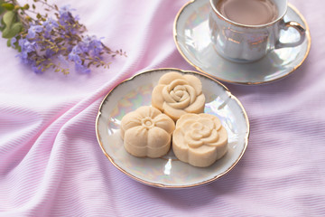 Home-made cheese tart on vintage ceramic plate with hot tea on sweet pink tone