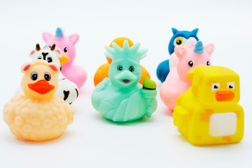 A group of colorful rubber ducks on an isolated white background.