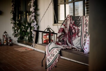 front porch with swing decorated for christmas