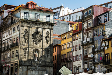 Ribeira square in the Port with bright colorful facades of buildings and cubic sculpture.