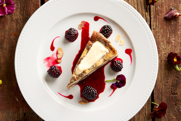 Poppy seed dough with blackberry on old wood table