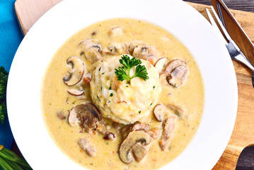 Sour mushroom sauce with bread dumpling (German name is Saure Schwammerlsoße mit Semmelknödel)