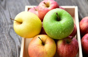 colorful of 3 Type of apple,Gala,Granny Smith,Golden Delicious in wooden box and wooden background.