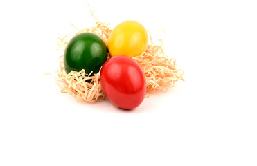 Colorful of Easter eggs on straw with white background and space for text.