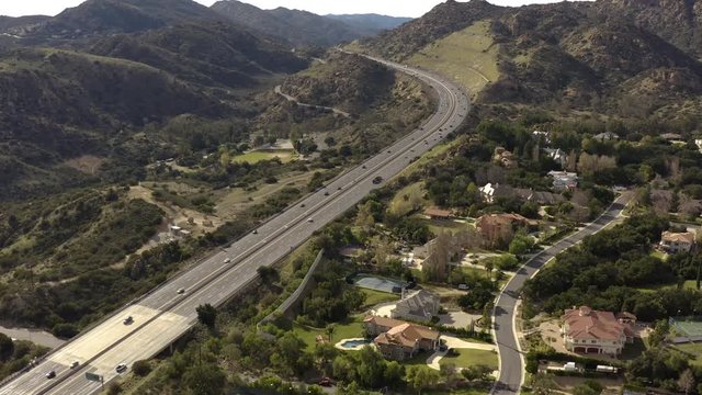 Aerial Drone Footage Slow Pan Up with Freeway in Small Valley