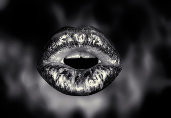 Closeup view of sexual beautiful female open metallic lips with white teeth. Isolated on dark fire background. Open sexy mouth. Cosmos and cosmic lip make up. Cosmetics concept. Sunsual girl kiss.