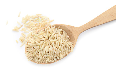 Wooden spoon with raw unpolished rice on white background, top view