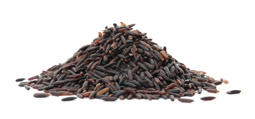 Pile of uncooked black rice on white background