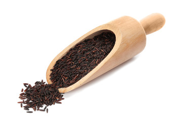 Scoop with uncooked black rice on white background