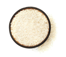 Plate with uncooked rice on white background, top view
