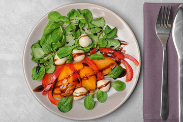 Vegetable salad with balsamic vinegar on grey background, top view