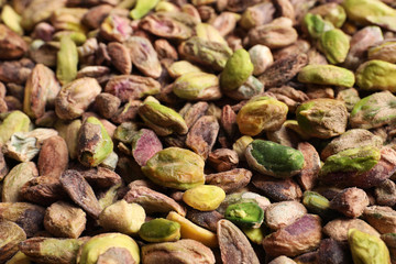 Shelled organic pistachio nuts as background, closeup