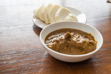 Nigerian pounded yam sliced served with banga Soup
