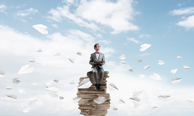 Young businessman or student in blue sky studying the science