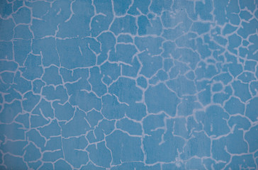 Old wall with blue cracked paint