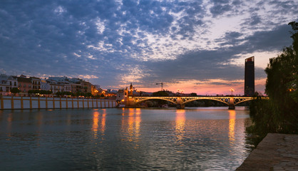 Naklejka premium Seville, Spain, Night view of the fashionable and historic districts of Triana