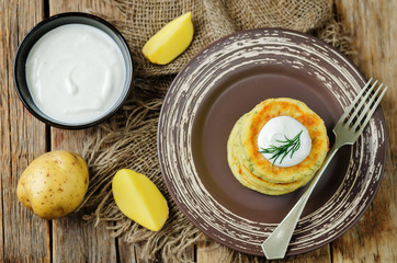 Cheese mashed potato cakes with sour cream and fresh dill