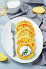 Cheese mashed potato cakes with sour cream and fresh dill