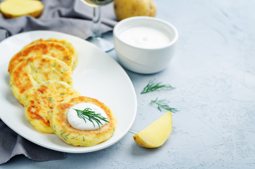 Cheese mashed potato cakes with sour cream and fresh dill