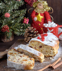 Fototapeta na wymiar Stollen, a traditional European cake with nuts and candied fruit, is dusted with icing sugar