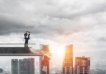 Man in suit looking up for new ideas.