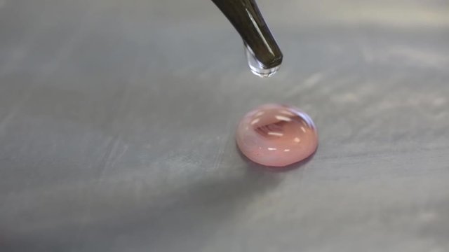 Chemistry laboratory experiment showing spot test for precipitate formation.