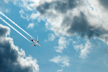 The plane against the blue sky and fluffy clouds. Concept of vacation, vacation, flight, travel.