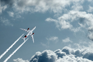 The plane against the blue sky and fluffy clouds. Concept of vacation, vacation, flight, travel.