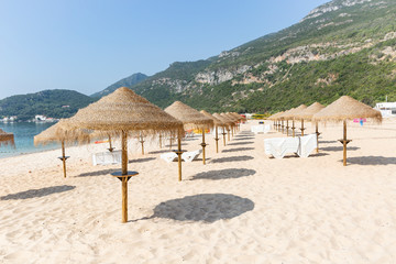 Straw Beach Umbrellas on Portinho da Arrabida Beach, Setubal, Portugal