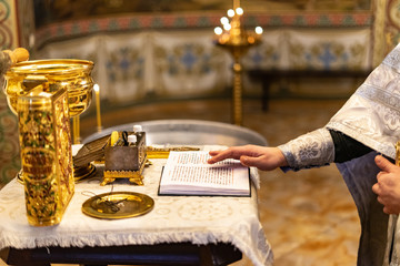 Golden stylish gospel in the orthodox church or temple on white table and  golden warm background