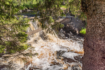 Foamy streams of water Tahmayoki River on the waterfall Ahinkoski