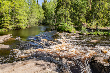 Foamy streams of water Tahmayoki River on the waterfall Ahinkoski