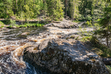 Foamy streams of water Tahmayoki River on the waterfall Ahinkoski
