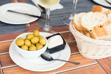 fresh olives with butter and slices of baguette