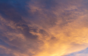 Clouds during sunset. The sky is dyed golden colors.