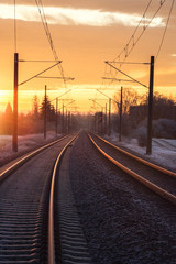 Fototapeta na wymiar Railroad lines through rural scenery at sunrise