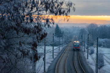 Modern German train  through snowy nature