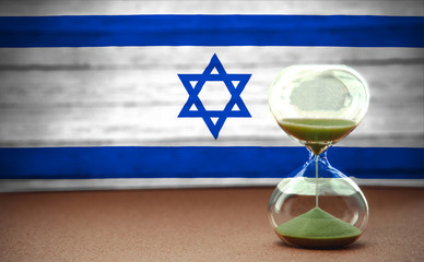 Hourglass on the background of the Israel flag, the concept of time and countries, space for text