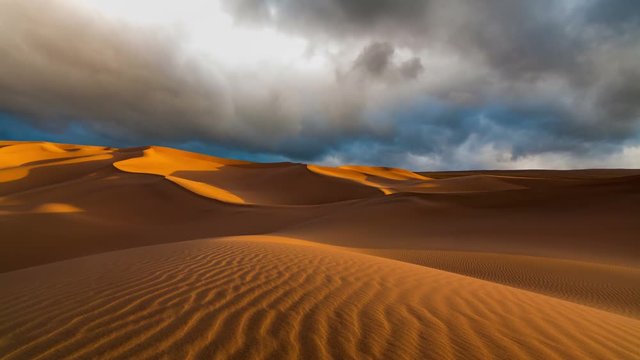 Sunset over the sand dunes in the desert