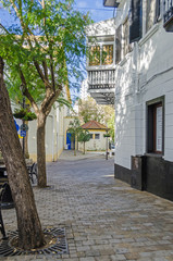 Fototapeta na wymiar Typical narrow street of Gibralta at the Cathedral square