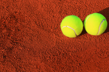 Tennis balls on a tennis clay court