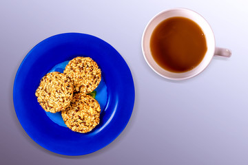 Coffee cup, blue plate of cookies, isolated. Top veiw.